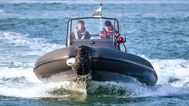 Two people at the helm of a RIB