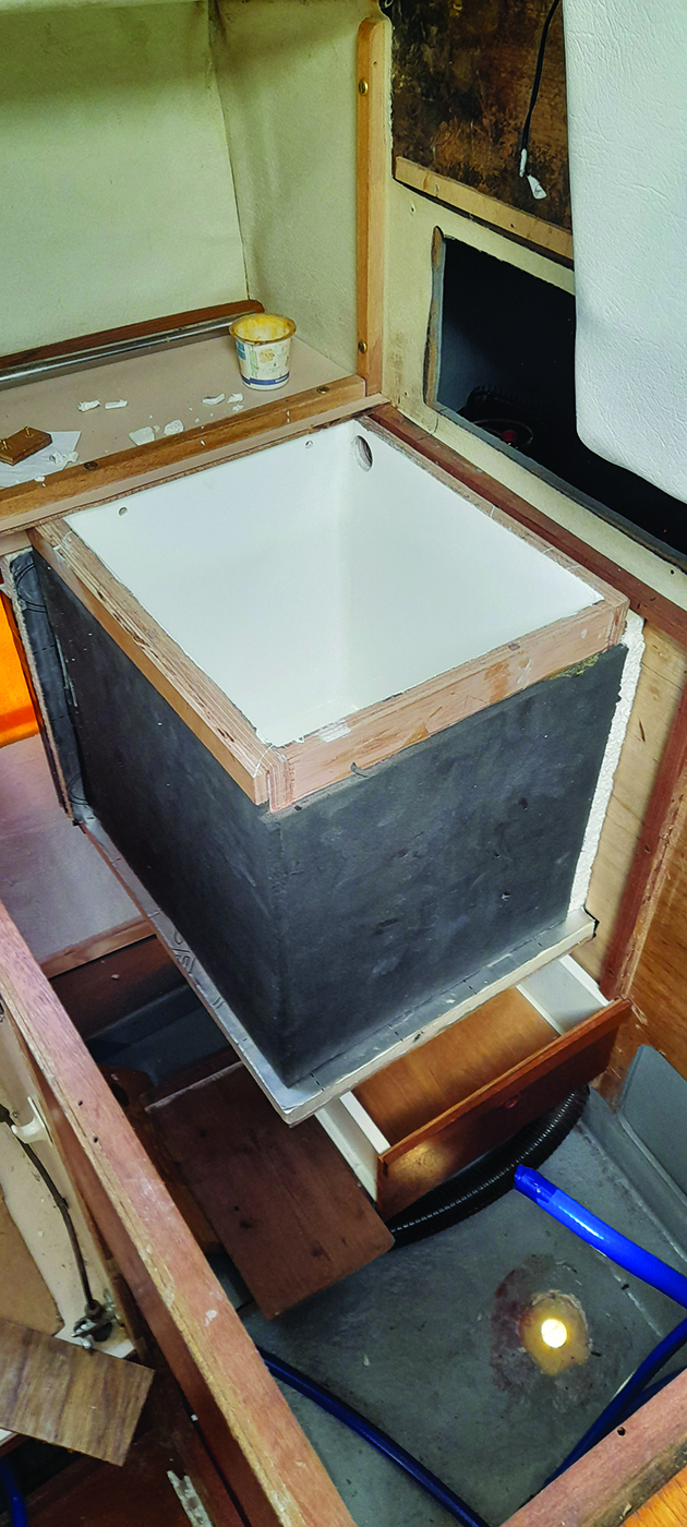 A DIY fridge being built on a boat