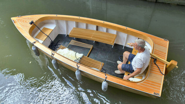A man at the tiller of a boat