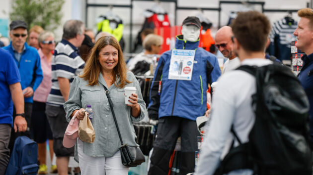 A person walking through the crowds at the Southampton boat Show