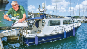 A man doing repairs to his boat