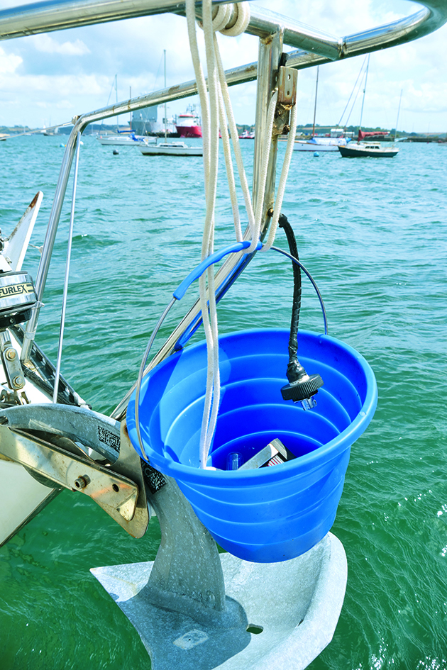 A blue bucket handing on a boat