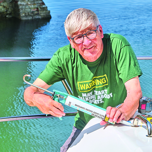 A man making changes to his boat to make it easier to go sailing