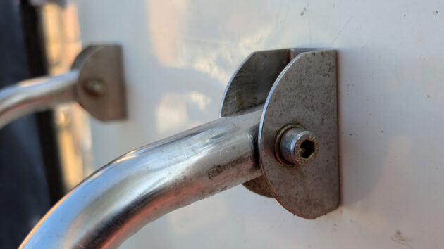 A stainless steel ladder hinge on a boat