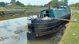 Excessively low water levels have left hundreds of boats stranded, including Adam McKinstry’s 45ft Oakwood at Gargrave since May – however the photo shows a silver lining, Adam has been able to 'do a bit of blacking on the bottom of the boat.'