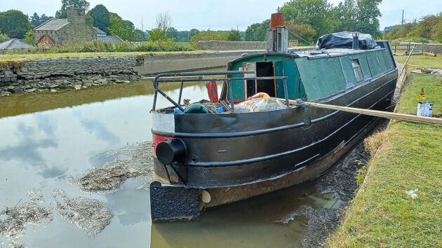 Excessively low water levels have left hundreds of boats stranded, including Adam McKinstry’s 45ft Oakwood at Gargrave since May – however the photo shows a silver lining, Adam has been able to 'do a bit of blacking on the bottom of the boat.'