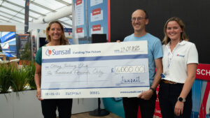 Round the world yachtswoman Dee Caffari and Otley Sailing Club's Rob McCandless with a Sunsail team member at the Southampton International Boat Show. Credit: Sunsail