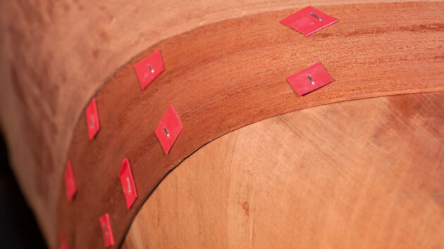 Veneer ply being left to dry on a canoe hull as part of the cold moulding process