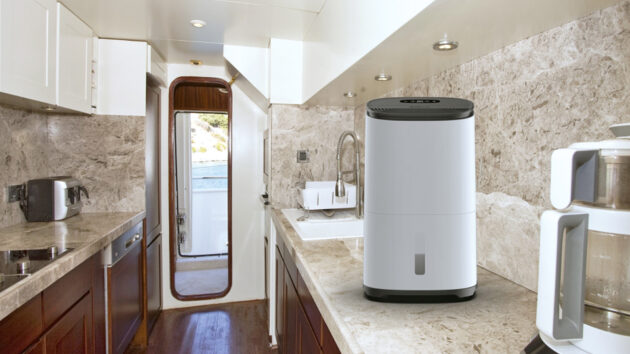 A dehumdifier on the counter of a boat galley