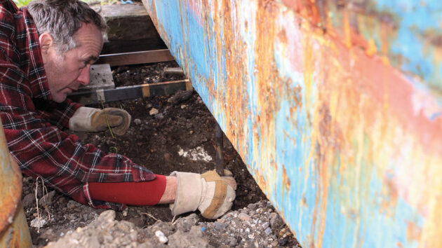 A man inspecting a keel bolt