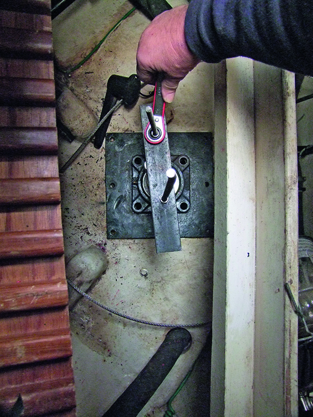 A puller being used on a boat steering system