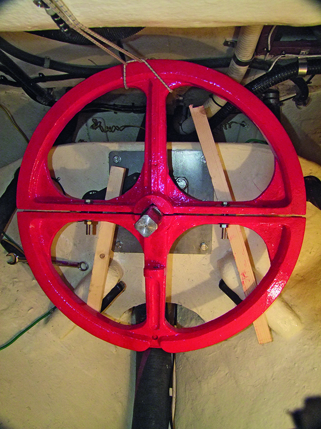 Wooden blocks by a steering quadrant on a boat steering system