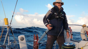 A man using a jury rudder to steer a boat