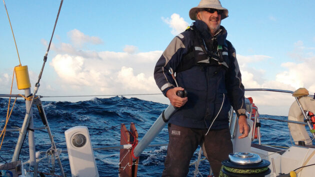 A man using a jury rudder to steer a boat