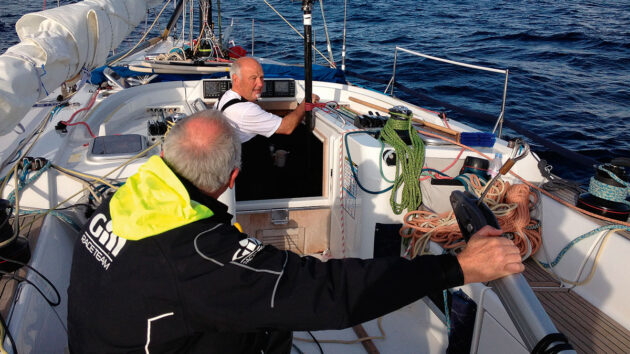 A man steering a boat with a jury rudder
