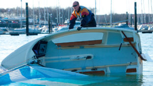 A man capsizing a Cornish Crabber 12 dinghy