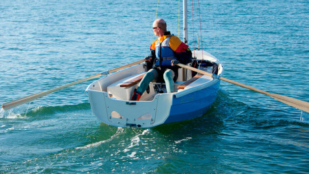 A man rowing a dinghy