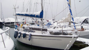 A boat moored in a marina covered in snow