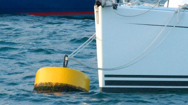 Mooring your boat: a boat moored to a mooring buoy