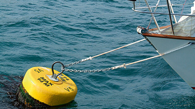 chain and rope spliced to secure a boat to a mooring buoy