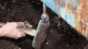 A man replacing keel bolts