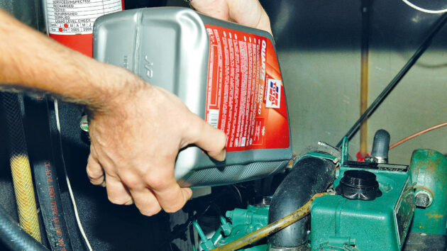Engine oil being poured into an engine on a boat