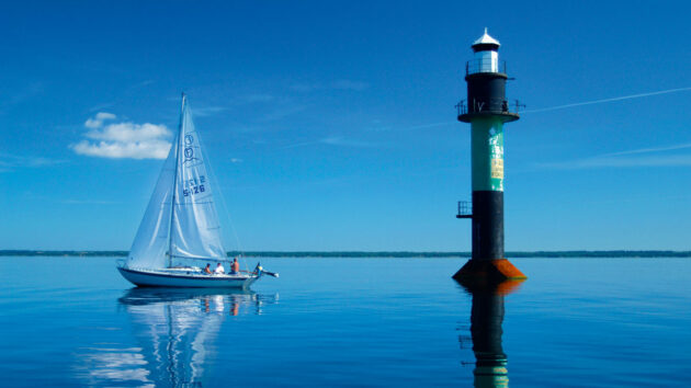 A Folkboat yacht sailing leaving no wake or wash