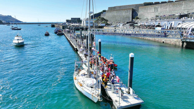 A yacht moored up alongside a pontoon