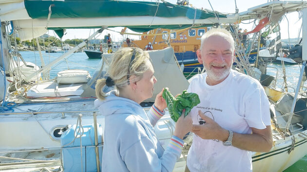 A man and a woman greeting each other on a boat pontoon