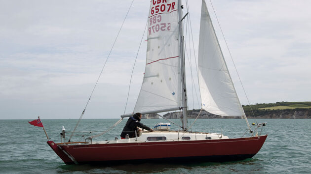A boat being heaved-to by a solo sailor