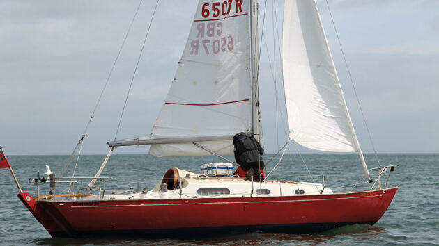 A man adjusting a sail on a boat
