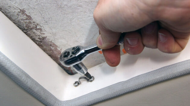 A socket driver being used on a boat