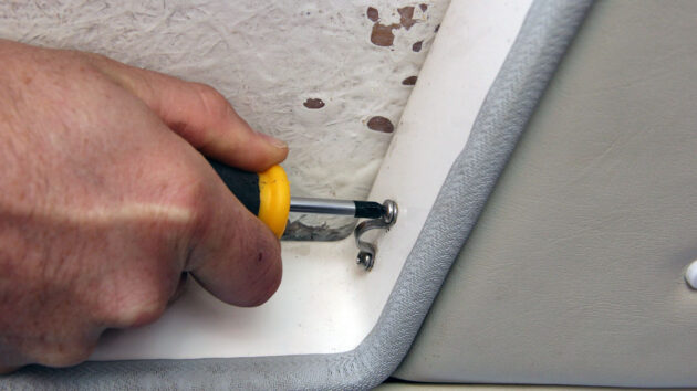 A stubby screwdriver being used on a boat, ideal tools for tights spaces