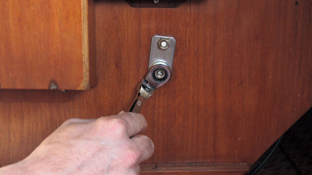 a swivel head ratchet being used on a boat, , part of tools for tight spaces to have onboard