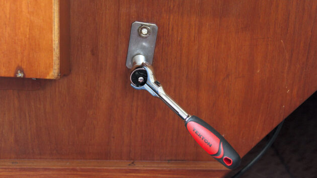 A swivel head hatchet being used on a boat, part of tools for tight spaces to have onboard