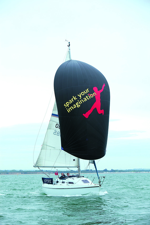 A yacht sailing with a spinnaker raised