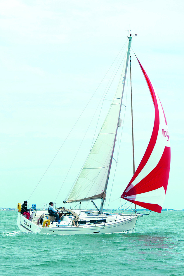 A yacht flying a cruising chute and sailing