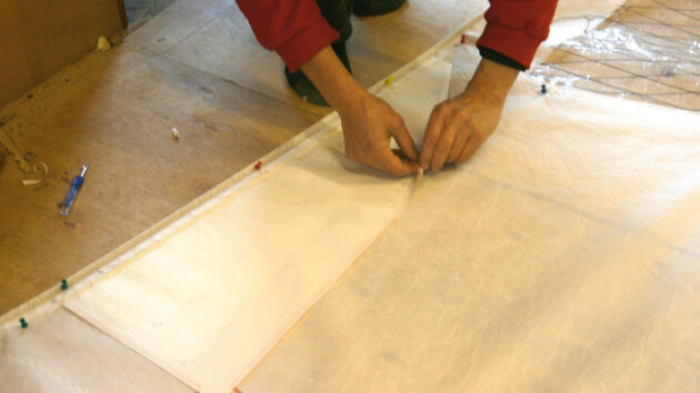 A man working on sail cloth
