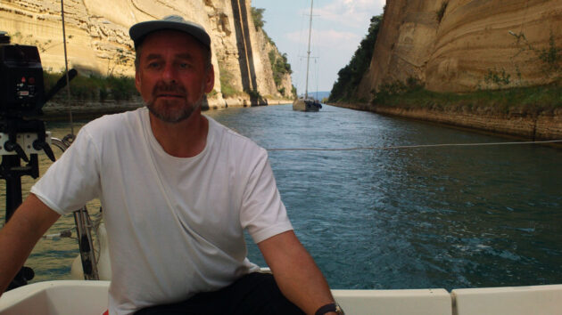 A man at the helm of a boat