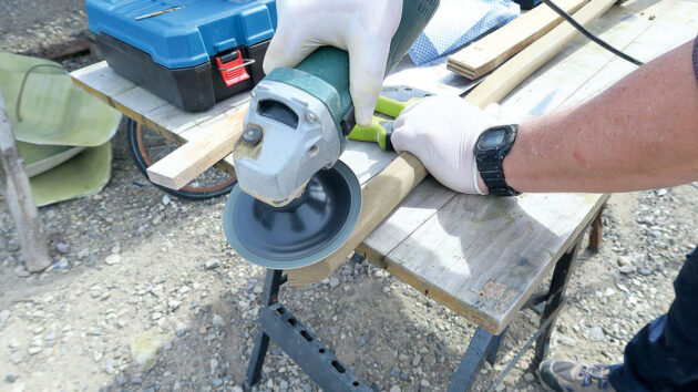 A man sanding PVC gunwale for a boat