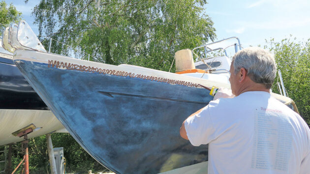 Adhesive being applied to a boat to stick on PVC gunwale