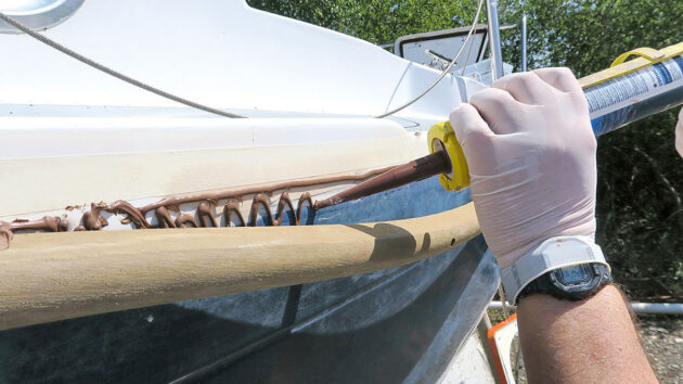Adhesive being applied to a boat to fit PVC gunwale