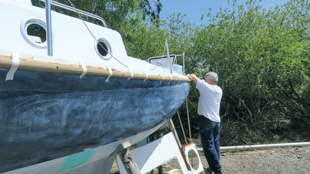 A man fitting PVC gunwale to a boat
