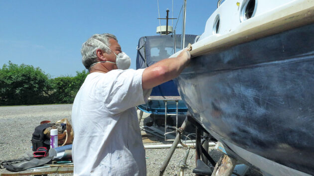 A man doing maintenance on his boat