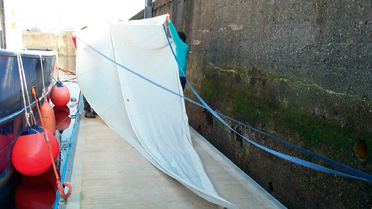 Old headsails being used as a sea anchor