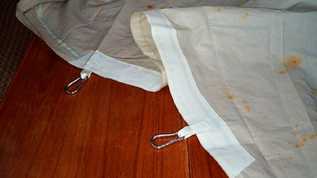 A sail with tape and shackles