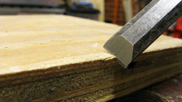 A chisel being used on a piece of wood
