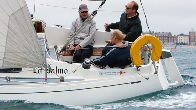 Men sailing in the cockpit of a boat