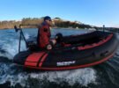 A man riding on a dinghy on the water