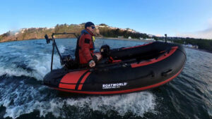 A man riding on a dinghy on the water